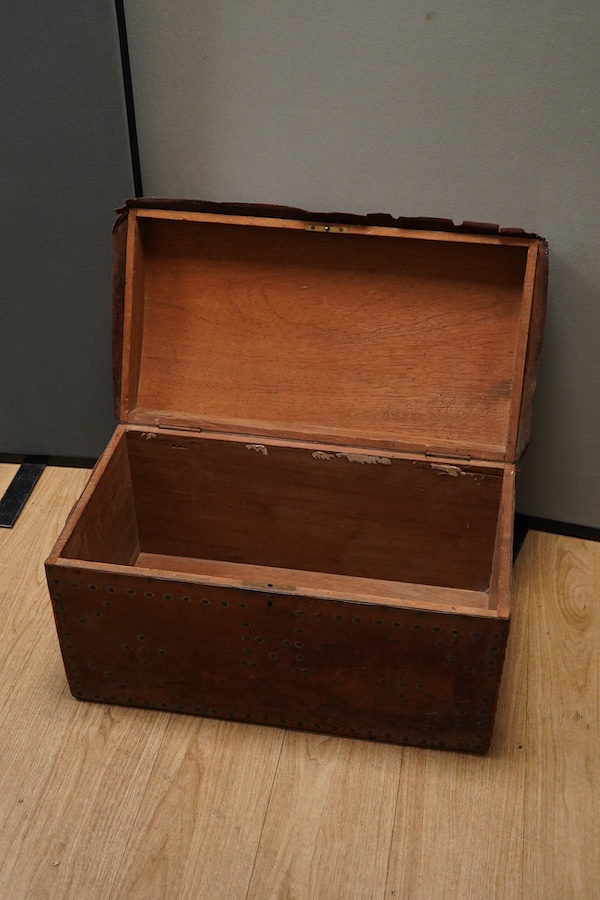 A 19th century leather and brass studded domed trunk, 65cm wide x 36cm high